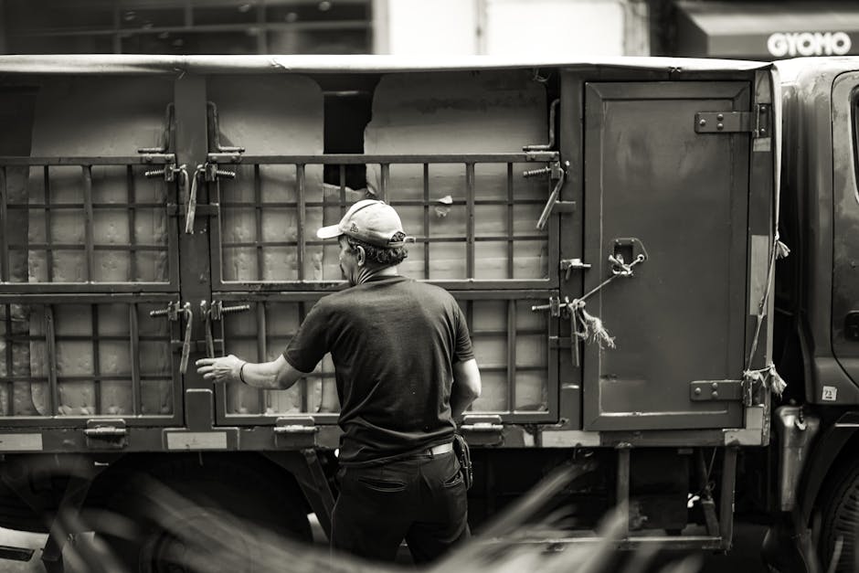 Professional movers loading heavy furniture into a moving truck